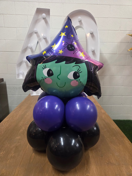 Witch Halloween-themed balloon centerpiece for party celebrations